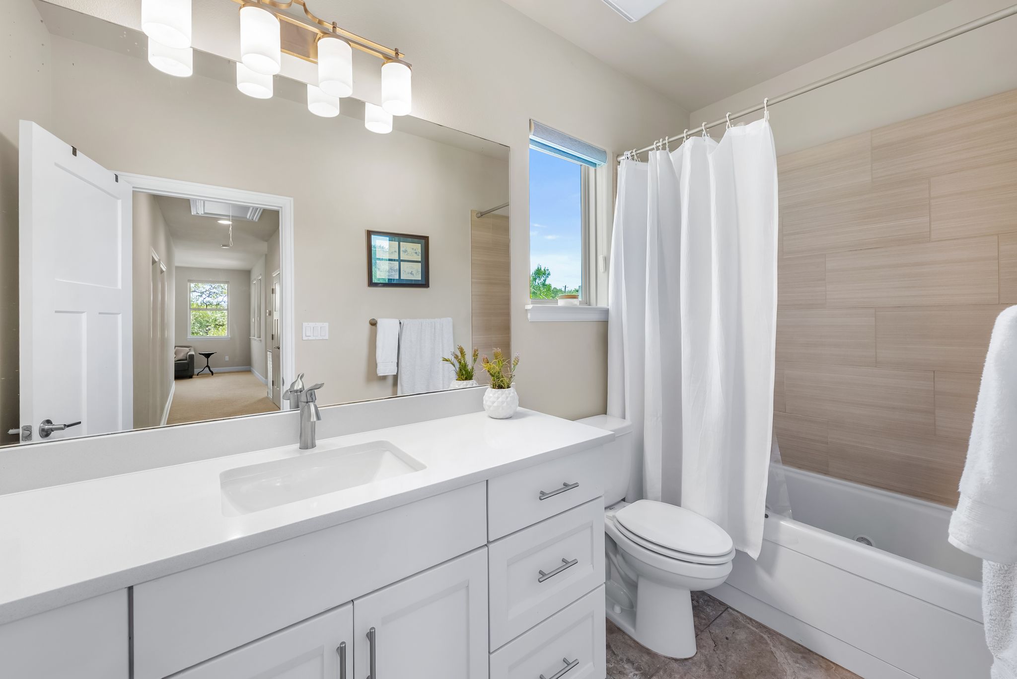 14213 Red Feather Trail Austin, TX 78734 - Photo 21 of 39 a bathroom with a sink a toilet a mirror a vanity and shower