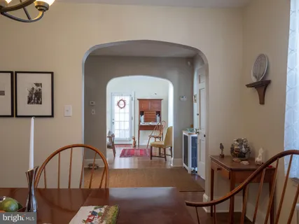 a kitchen with a table chairs sink and cabinets