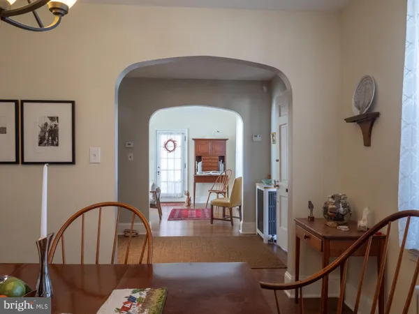 a kitchen with a table chairs sink and cabinets
