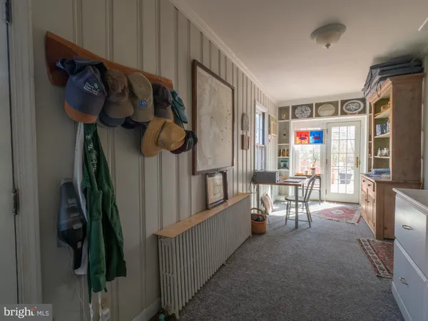 a hallway with a view of kitchen and dining room