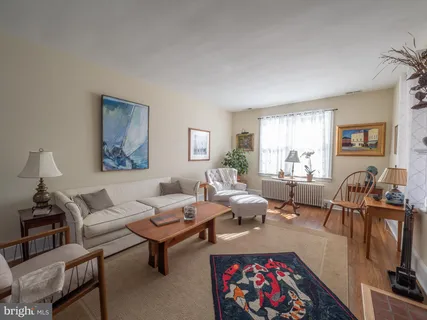 a living room with furniture a rug and a window