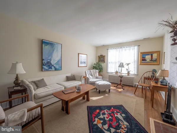 a living room with furniture a rug and a window