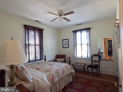 a living room with furniture and a book shelf