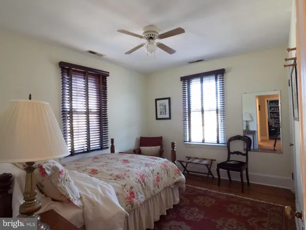 a living room with furniture and a book shelf