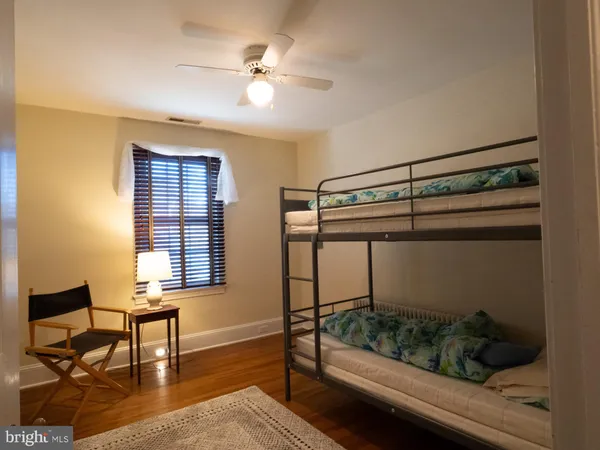 a view of a house with wooden deck and furniture