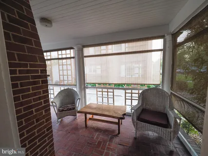 a view of a brick house with many windows and a yard