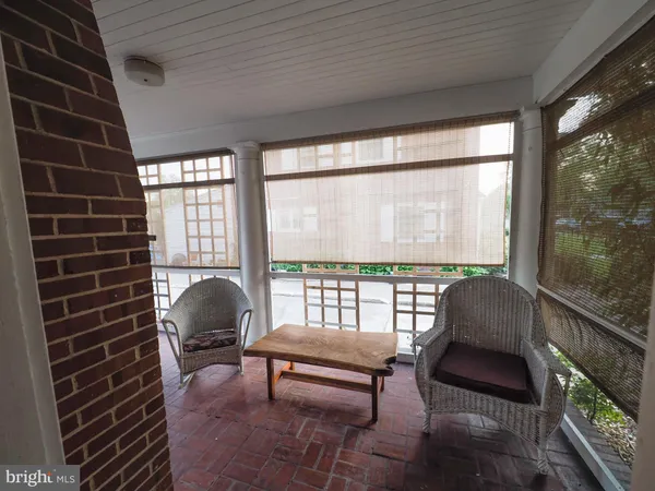 a view of a brick house with many windows and a yard