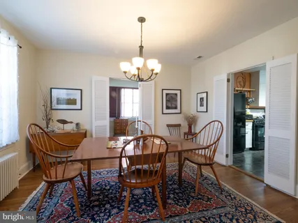 a view of a dining room with furniture and chandelier
