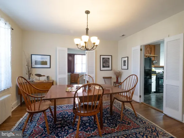a view of a dining room with furniture and chandelier