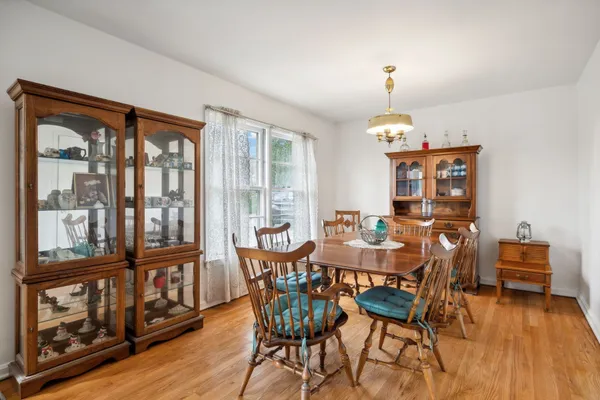 a view of a dining room with furniture wooden floor and chandelier