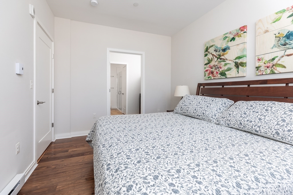 3531 Washington Street, Unit 322D Boston, MA 02130 - Photo 11 of 24 a bedroom with a bed and painting on the wall