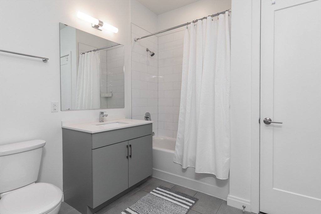 3531 Washington Street, Unit 322D Boston, MA 02130 - Photo 18 of 24 a bathroom with a sink a toilet and shower