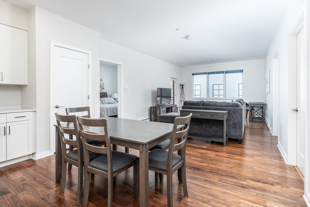 3531 Washington Street, Unit 322D Boston, MA 02130 - Photo 3 of 24 a view of a dining room with furniture and wooden floor