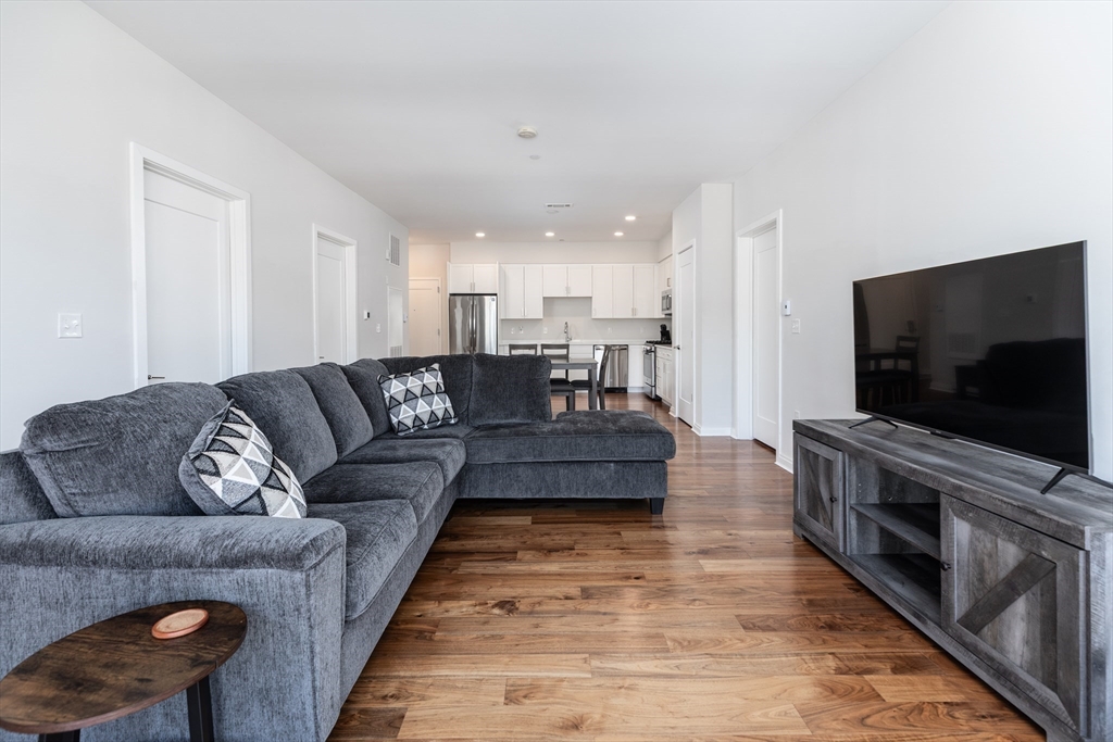 3531 Washington Street, Unit 322D Boston, MA 02130 - Photo 5 of 24 a living room with furniture and a flat screen tv