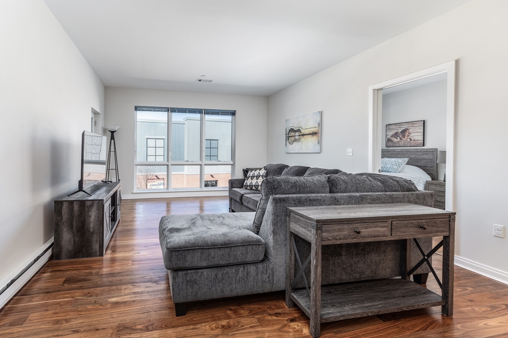 3531 Washington Street, Unit 322D Boston, MA 02130 - Photo 6 of 24 a living room with furniture and a flat screen tv