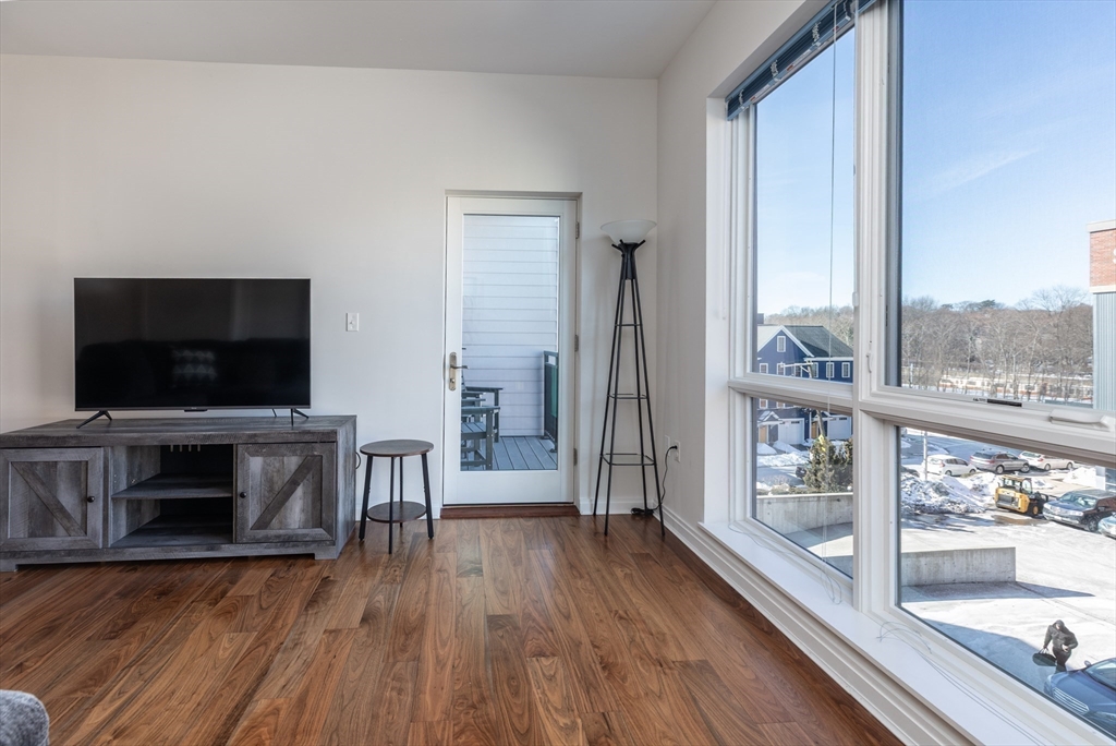 3531 Washington Street, Unit 322D Boston, MA 02130 - Photo 7 of 24 a living room with a flat screen tv and a fireplace