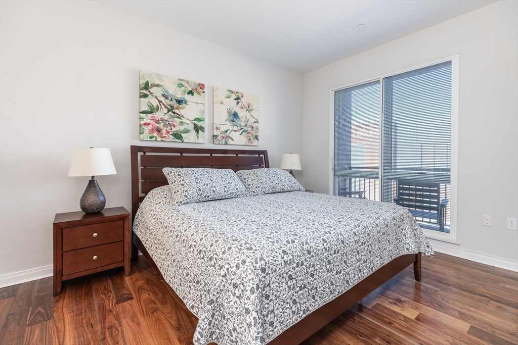 3531 Washington Street, Unit 322D Boston, MA 02130 - Photo 9 of 24 a bedroom with bed and wooden floor