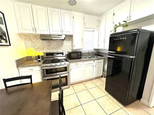 a kitchen with a stove and a dining table