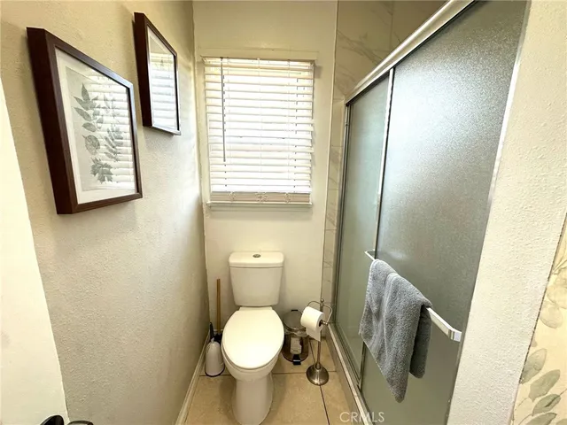 a bed sitting in a bedroom next to a window with outer view