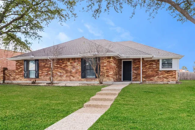a front view of a house with a yard and porch