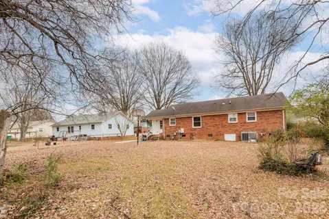 a front view of a house with a yard covered in snow