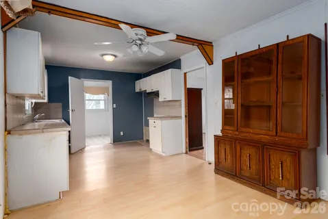 a view of a kitchen with refrigerator and cabinet