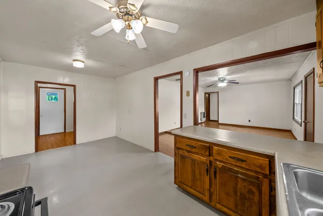 a kitchen with cabinets a sink and appliances