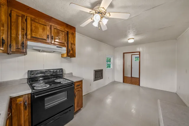 a kitchen with stainless steel appliances granite countertop a stove and a sink
