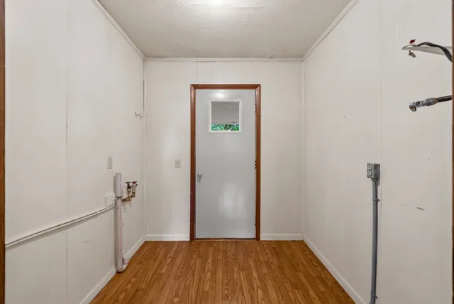 a view of a room with wooden floor