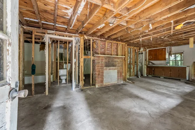 a view of livingroom with refrigerator and window