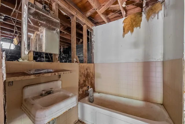 a bathroom with a tub and sink