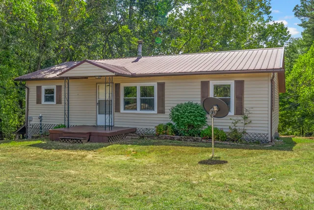 a view of a house with a yard and plants