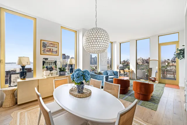 a dining room with furniture a chandelier and wooden floor