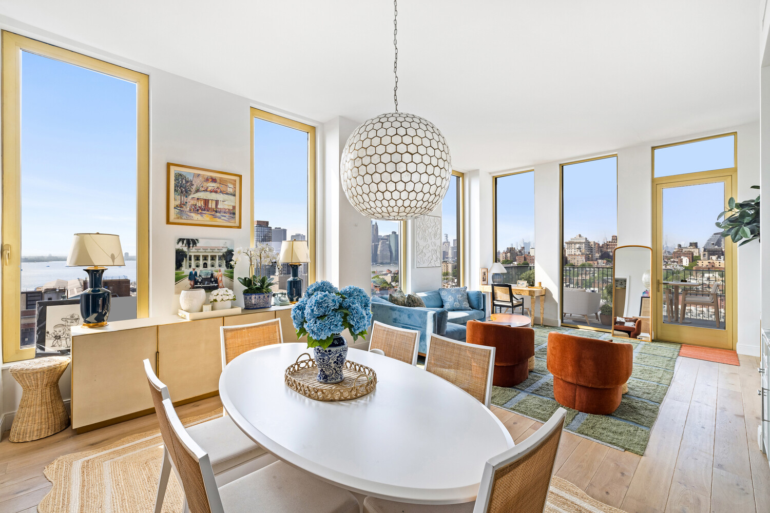 a dining room with furniture a chandelier and wooden floor