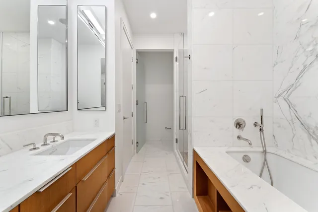 a spacious bedroom with a bed and a large window