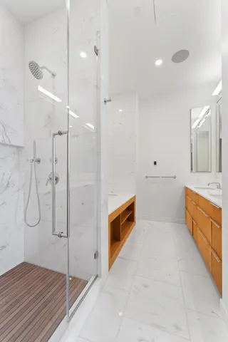 a bathroom with a tub sink and mirror