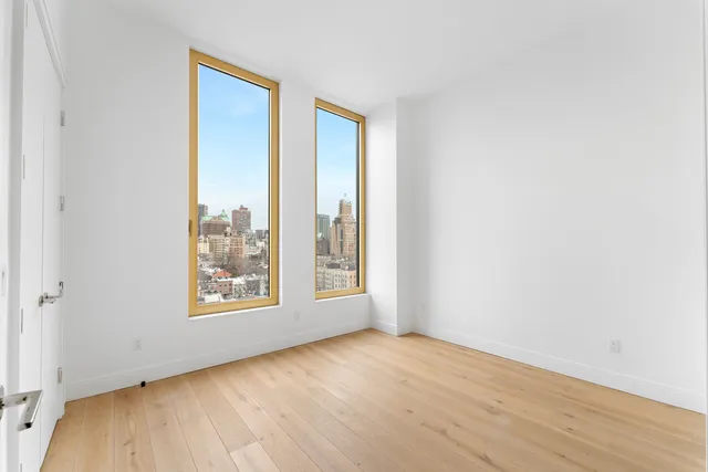 a bedroom with two beds and a window