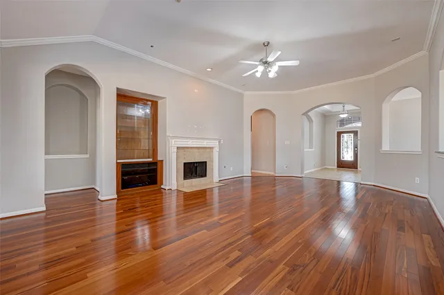 a view of empty room with wooden floor and fireplace