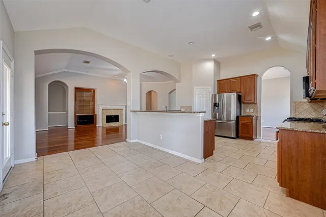 a view of a kitchen with a sink and an empty room
