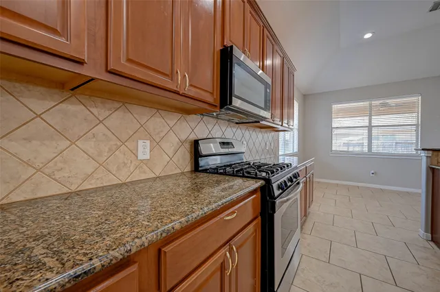 a spacious bathroom with a granite countertop sink and mirror