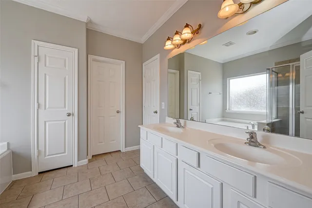a bathroom with a tub sink and mirror