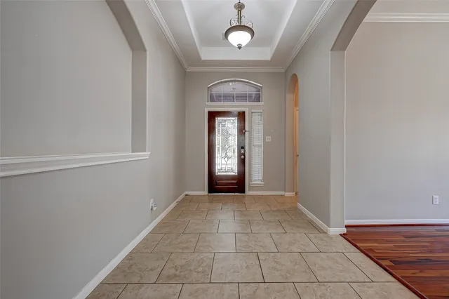 a view of a hallway with wooden floor and a window