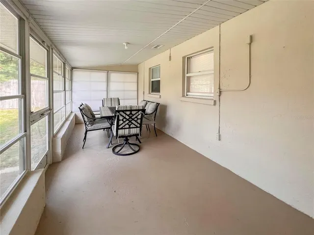 a view of a livingroom with furniture wooden floor and windows