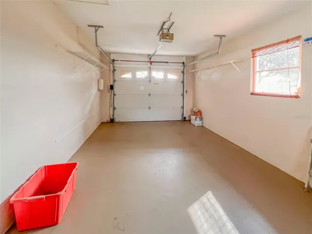 an empty room with windows and fireplace