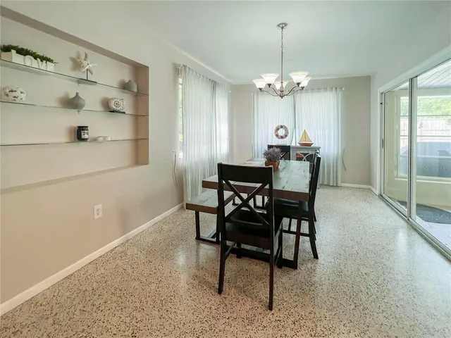 a view of a dining room with furniture and a chandelier