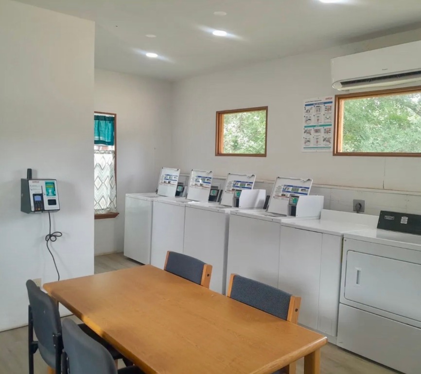 270 Hidden Path Lockhart, TX 78644 - Photo 2 of 27 a room with a table chairs refrigerator and sink