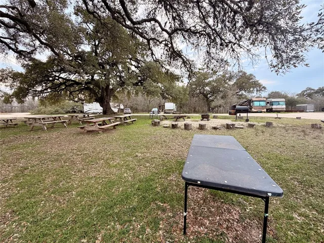 a backyard of a house with table and chairs
