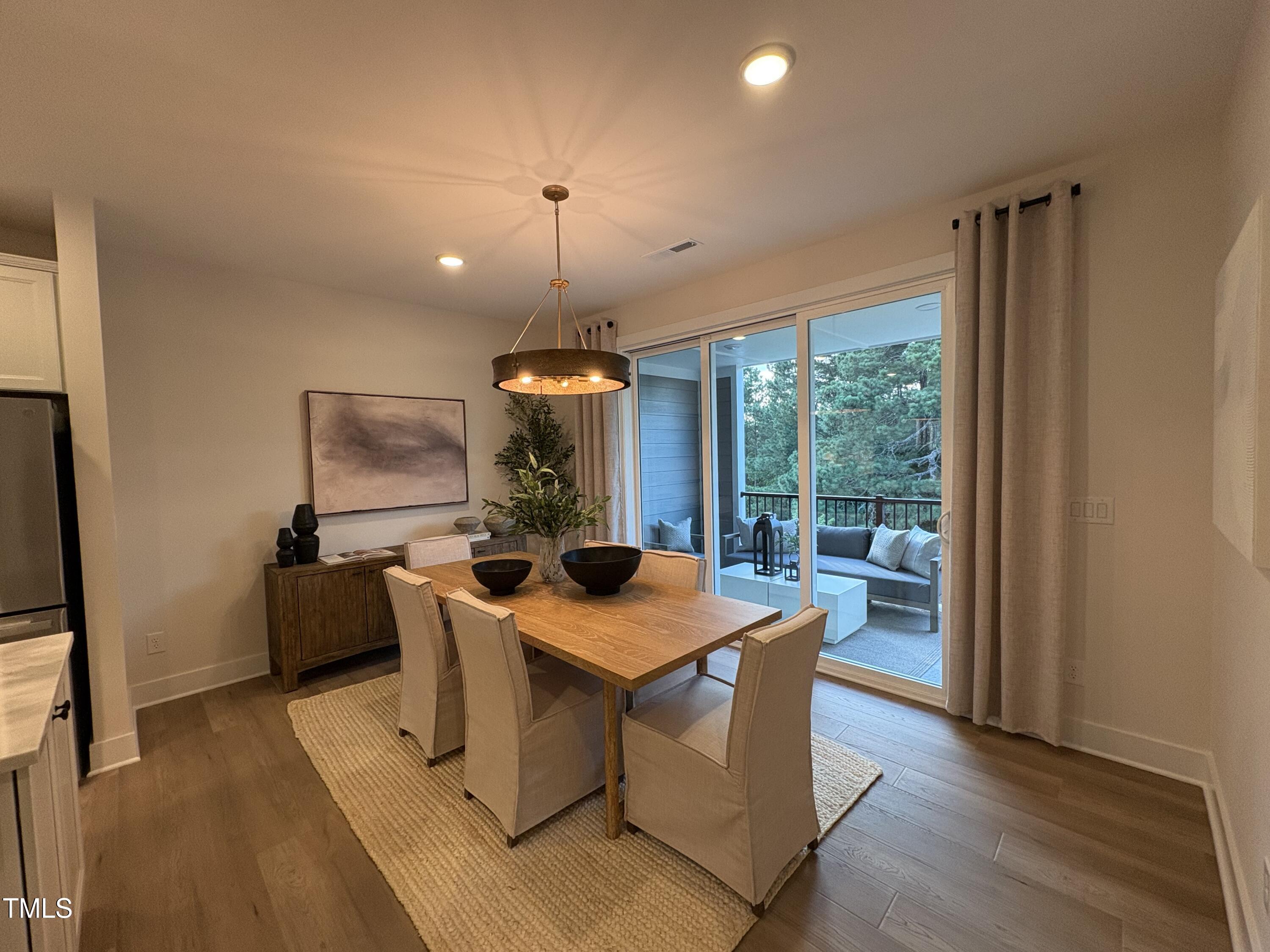 10907 Bayflower Way Raleigh, NC 27617 - Photo 4 of 22 a view of a dining room with furniture window and wooden floor