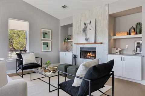 a living room with furniture and a fireplace