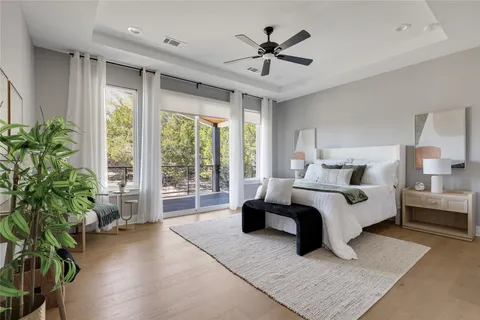 a spacious bedroom with a large bed and a potted plant